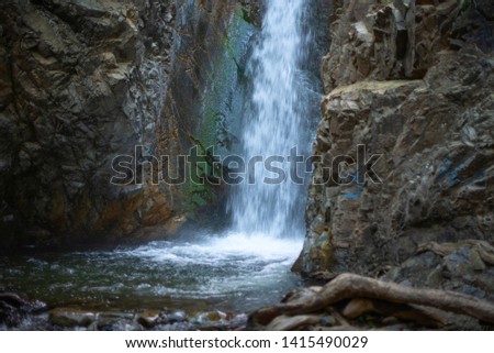 waterfall (shot at long exposure) and the dark rocks