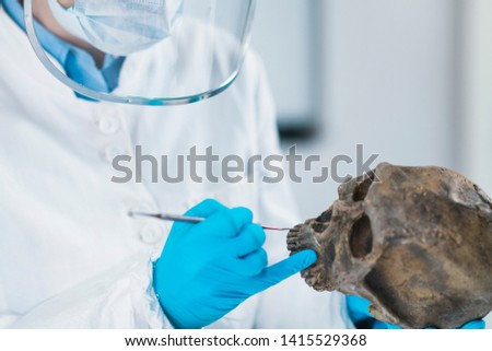 Ancient DNA Analysis. Female scientist holding micro tube with sample in ancient DNA laboratory. Royalty-Free Stock Photo #1415529368