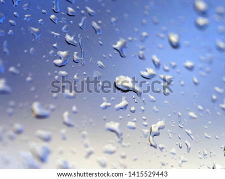 Wet glass window, after rain sky background