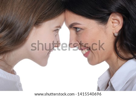 Portrait of happy mother and daughter posing on white background