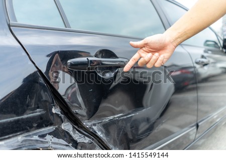 Man hand pointing on car bumper dented broken on black car door. injury car claim for insurance.
Vehicle car crash damage accident on road. Insurance claim concept. Royalty-Free Stock Photo #1415549144