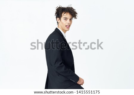 A guy with curly hair and in a business suit                  