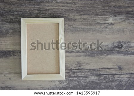 Wooden photo frame vertical on wood background