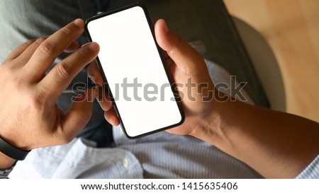 Top view man using blank screen mobile phone