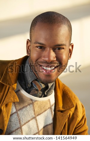 Close up portrait of a handsome african american man smiling outdoors