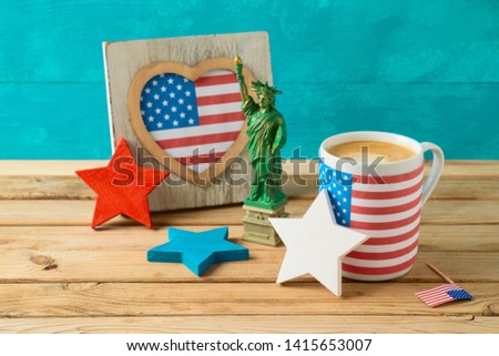 Happy Independence Day, 4th of July celebration concept with coffee cup and american flag on wooden table