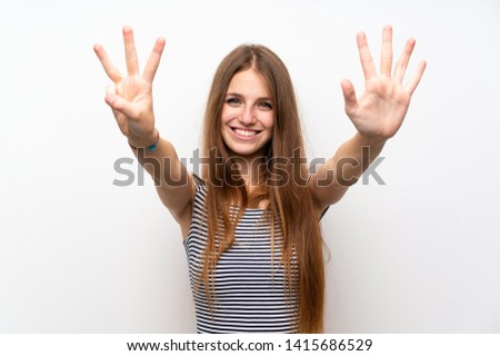 Young woman with long hair over isolated white wall counting eight with fingers