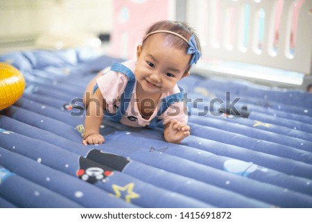 asian baby girl playing on the floor