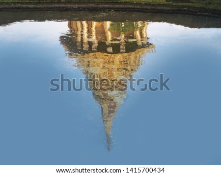 
Reflection on the water surface Is a picture of a temple pagoda.