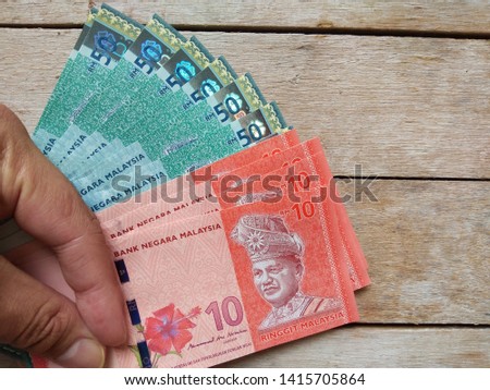 Bundle of money. Malaysia Currency (MYR): RM50 and RM10