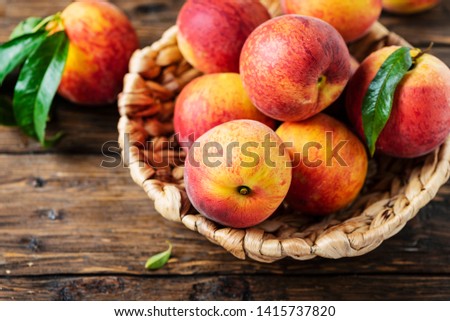 Fresh sweet peaches on the wooden table, selective focus Royalty-Free Stock Photo #1415737820