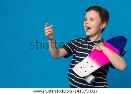 cheerful teenager with skateboard in hand laughs, lifestyle concept