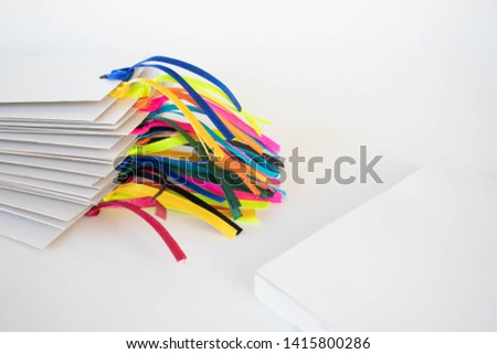 Bookmarks with ribbons and a book on a white background
