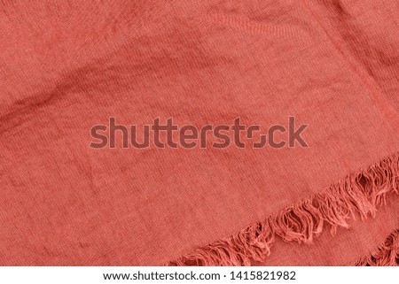 Coral colored pure linen texture. Wrinkled linen fabric background. Natural linen blanket cloth in living coral color