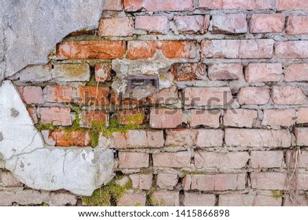 Aged red brick wall with a crack. Grunge style. Creative photo for the designer. damaged , the problem of major repairs of houses