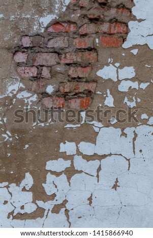 Aged red brick wall with a crack. Grunge style. Creative photo for the designer. Copy space. abandon , the problem of major repairs of houses