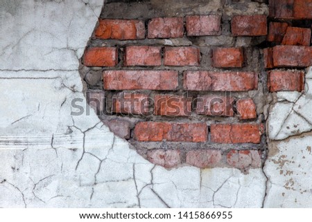 Aged red brick wall with a crack. Grunge style. Creative photo for the designer. Copy space. decay , the problem of major repairs of houses