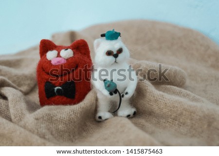 two toy cats from felt meaning husband and wife showing family relationships