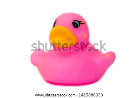 Rubber bath duck isolated on white. A side view of a pink rubber duck.