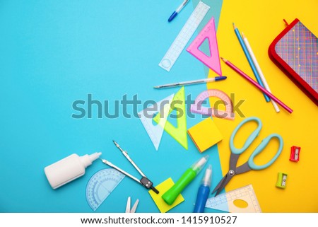 Starting school, back to school, education are styled flat lay scene with school supplies on blue and yellow background. Copy space