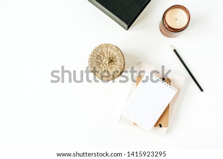 Minimalist office desk workspace with notebook on white background. Flat lay, top view blank paper copy space mock up.