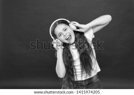 Modern gadget concept. Music taste. Music plays an important part lives teenagers. Powerful effect music teenagers their emotions, perception of world. Girl listen music headphones on red background.