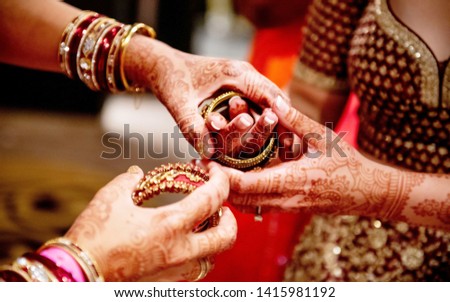 Indian bride getting her wedding bangles Royalty-Free Stock Photo #1415981192