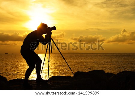 Silhouette photographer at sunset