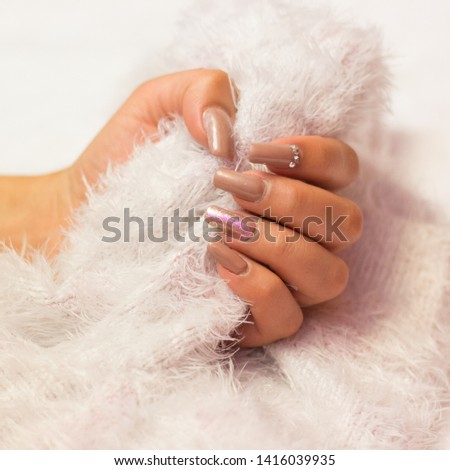 Pink manicure with shine and siren effect on a white background