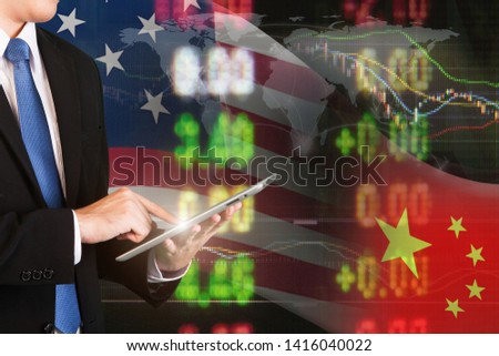 USA and China trade war economy with business planning strategy analysis by online technology. Business man use tablet focusing on USA and China trade war economy by intetnet network.