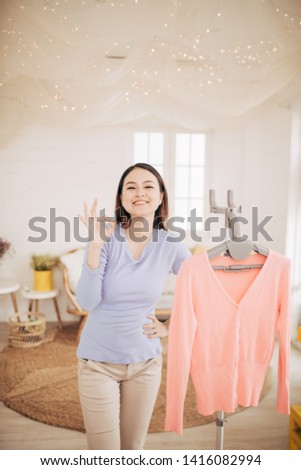 Funny foxy woman dancing with steamer iron. Housewife having fun while ironing clothes