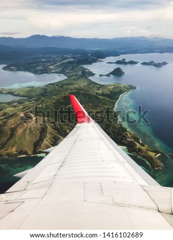 Tropical island coastline view from the plane. Travel and vacations concept. Flores, Labuan Bajo. Indonesia