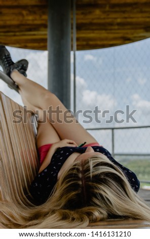Beauty young caucasian blonde woman lying with legs up