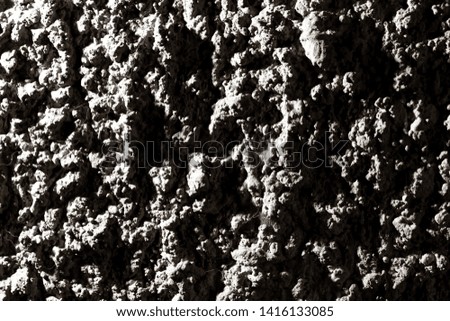 Black wall of sand and concrete as an abstract background .