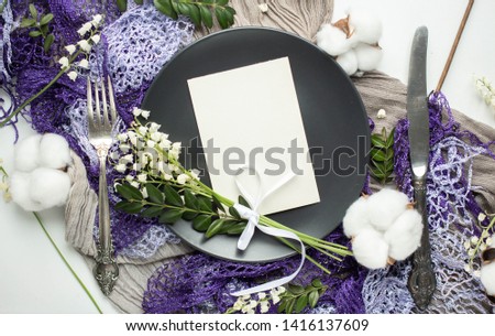 Beautiful spring wedding event table set up with boho style lilies of the valley flower decoration. Top view flat lay