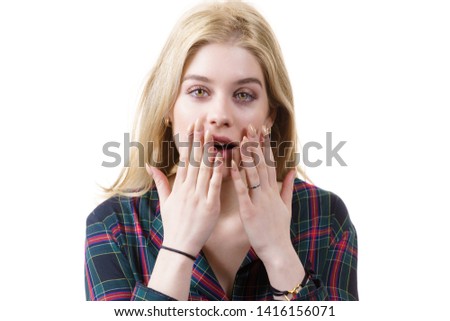 Amazed astonished young woman being suprised or shocked by something. Female having shock face expression.