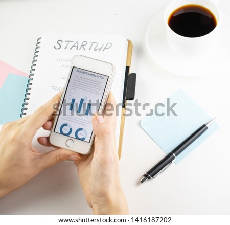 Minimalistic workplace concept, with a stationery, pen and business work records on a white background. Image of business plan, startup. Top view. Flat lay style