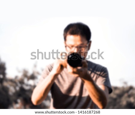 Soft focus of men photographer hold camera and taking a photo