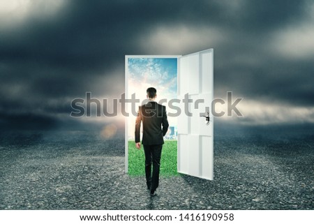 Businessman with creative opportunity door on abstract outdoor sky landscape background. Success and doorway concept  Royalty-Free Stock Photo #1416190958