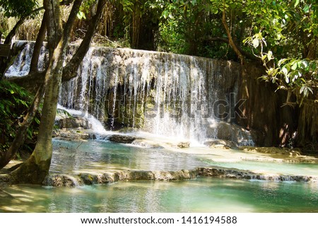 Water fall  in the fores park , beautiful   landscape  nature  view  under day light use for background or wallpaper .