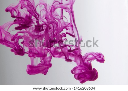 Color paint drops in water. Ink swirling underwater. Cloud of silky ink collision on white background. Colorful abstract smoke explosion animation. Close up camera view.