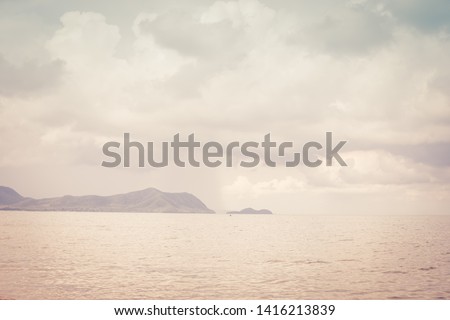 Background image of a beautiful sea horizon with clouds above it in Thailand, toned