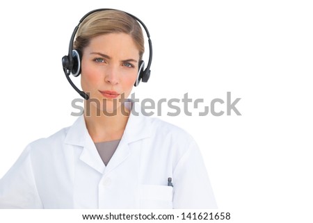 Serious nurse using headset and looking at the camera