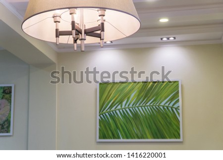 lamp on the ceiling and painting on the wall. interior of a fashionable restaurant