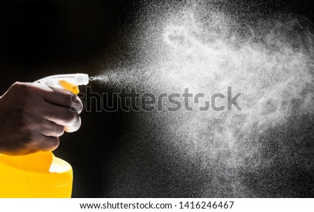 bottle nozzle spraying water on black background  - Image 