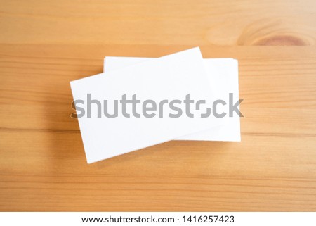 Blank business cards on wooden surface.