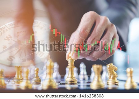 Business hand play chess game to development analysis new strategy plan with stock graph, leader and teamwork concept
