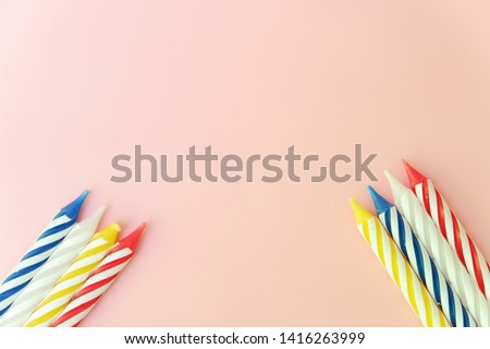 Colourful candles isolated on pink background. Birthday,Christmas and special greetings concept.
