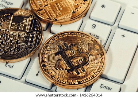 Golden bitcoin coin cryptocurrency on the laptop keyboard.