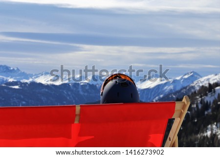 Skier enjoying the nice weather in the deck chair